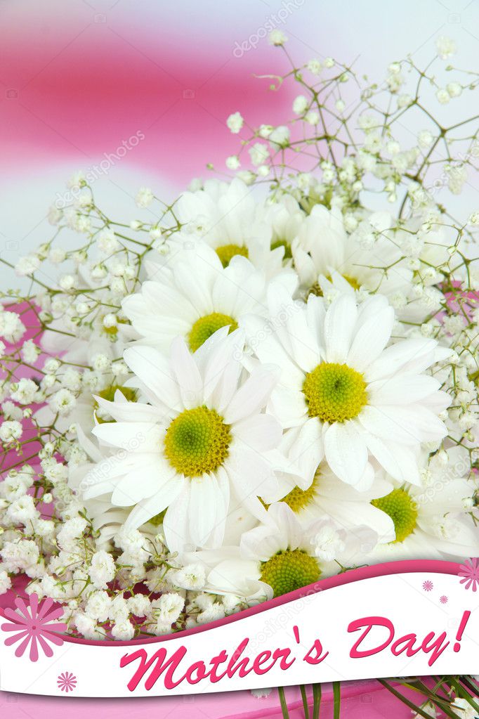 Beautiful flowers on table on bright background