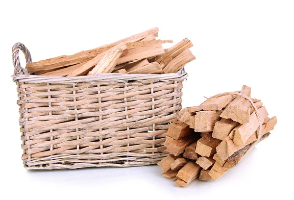 Stack of firewood in wicker basket isolated on white — Stock Photo, Image