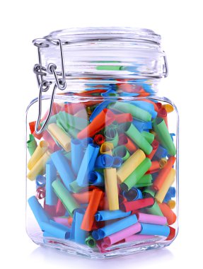 Dreams written on color rolled paper in glass jar, isolated on white clipart