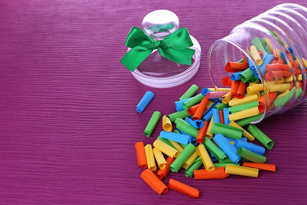 Dreams written on color rolled paper in glass jar, on color background — Stock Photo, Image