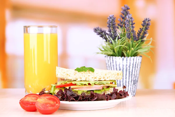 Fresh and tasty sandwich on plate on table on light background — Stock Photo, Image