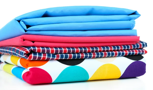 Pile of colored fabrics isolated on white — Stock Photo, Image