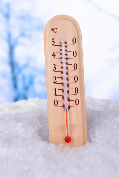 Thermometer in snow on light background — Stock Photo, Image