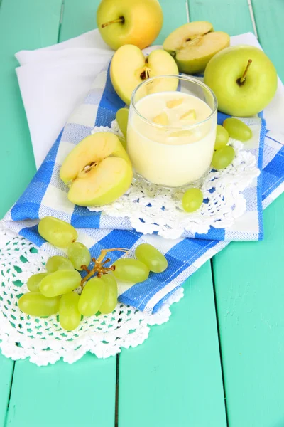 Delicious yogurt in glass with fruit on wooden table close-up — Stock Photo, Image