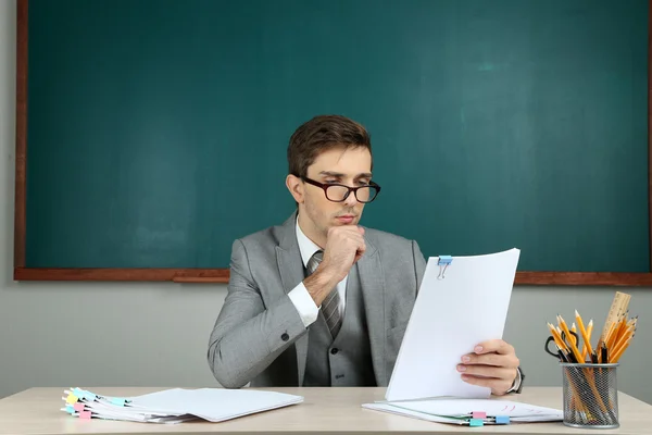 Giovane insegnante seduto in classe scolastica — Foto Stock