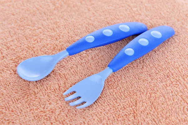 Baby fork and spoon on towel background — Stock Photo, Image