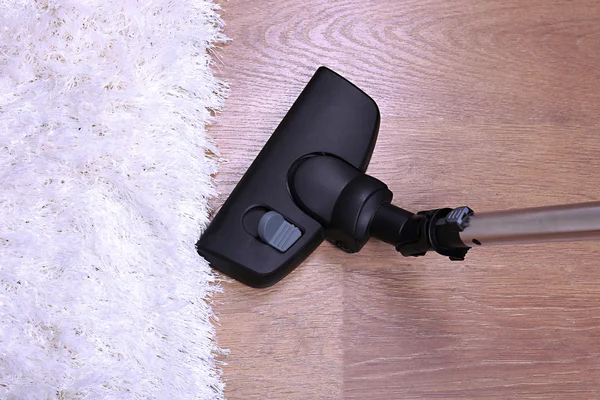 Vacuuming carpet in house — Stock Photo, Image