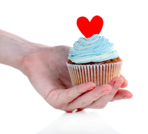 Tasty cupcake with butter cream in female hand, isolated on white — Stock Photo, Image