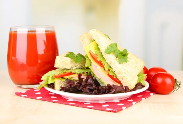 Fresh and tasty sandwiches on plate on table on light background — Stock Photo, Image