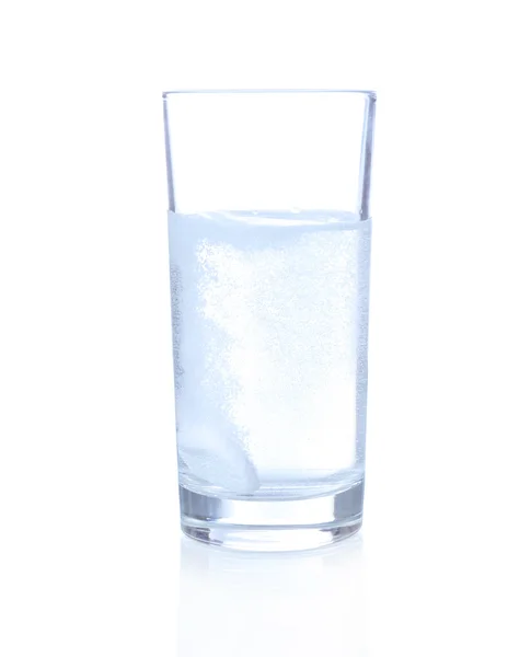 Glass with efervescent tablet in water with bubbles isolated on white — Stock Photo, Image