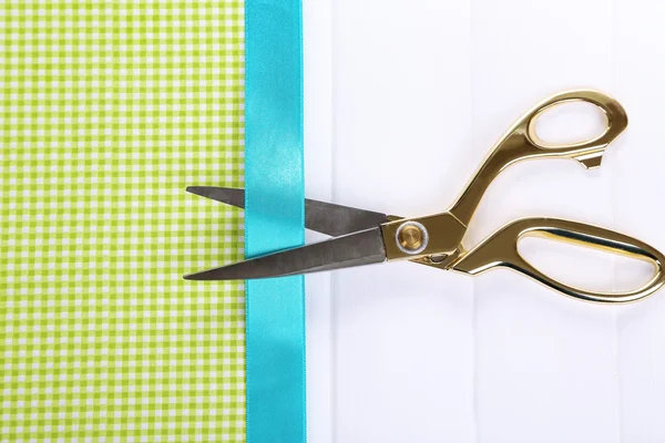 Scissors on color fabric background — Stock Photo, Image