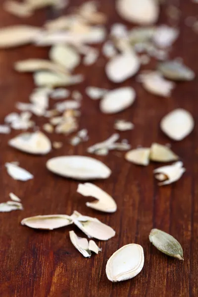 Peeled pumpkin seeds on wooden background — Stock Photo, Image