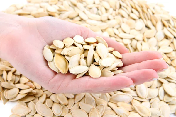 Pumpkin seeds in hand close up — Stock Photo, Image