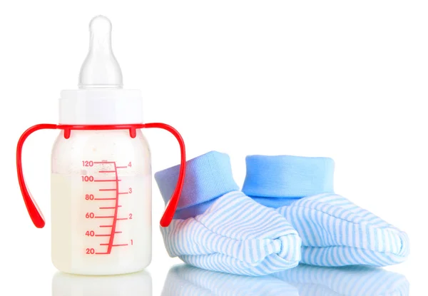 Bottle for milk formula with booties isolated on white — Stock Photo, Image