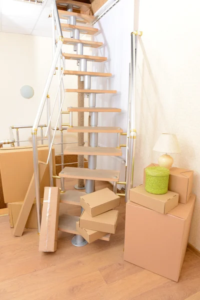Pila di cartoni vicino alle scale: concetto di casa in movimento — Foto Stock