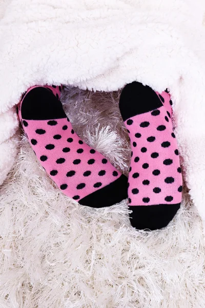 Female legs in colorful socks on white carpet background — Stock Photo, Image