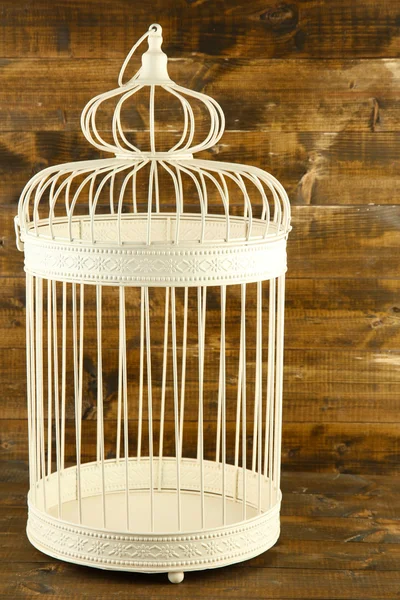 Beautiful decorative cage, on wooden background — Stock Photo, Image
