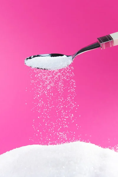 Sugar on red background — Stock Photo, Image