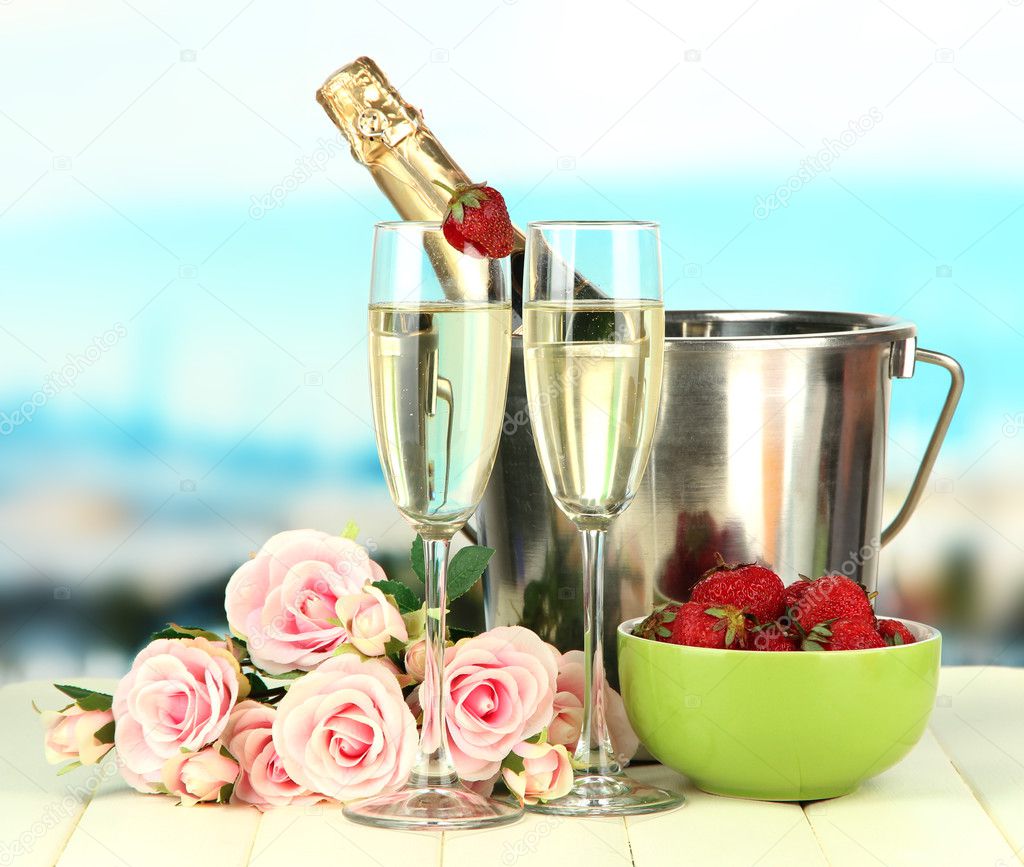 Romantic still life with champagne, strawberry and pink roses, on bright background