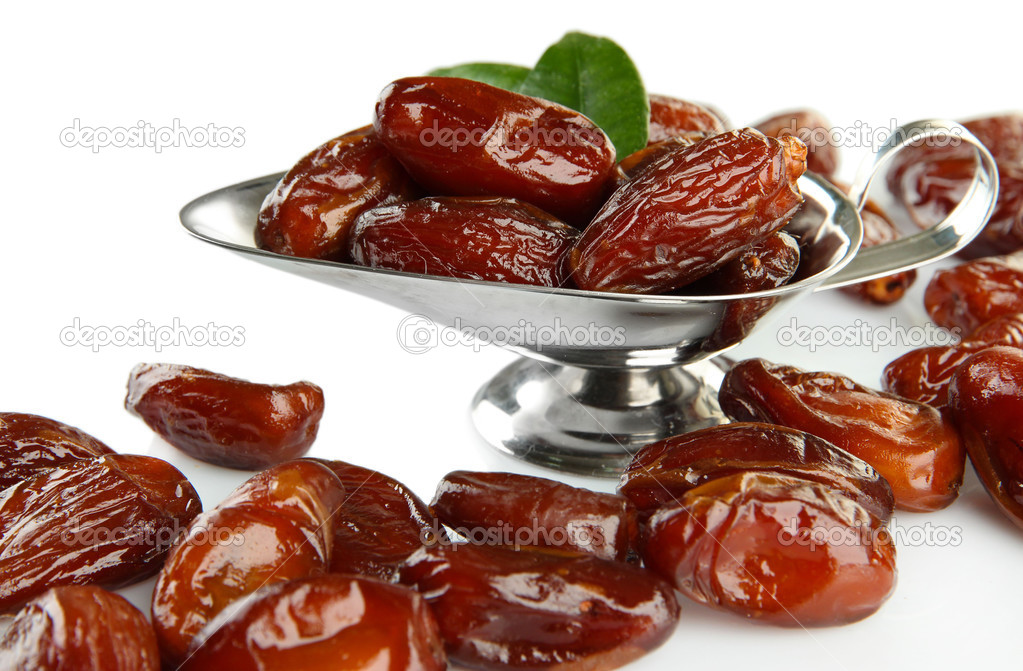 Dried dates in metal dish isolated on white