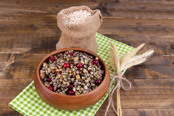 Plate with kutia - traditional Christmas sweet meal in Ukraine, Belarus and Poland, on wooden background — Stock Photo, Image