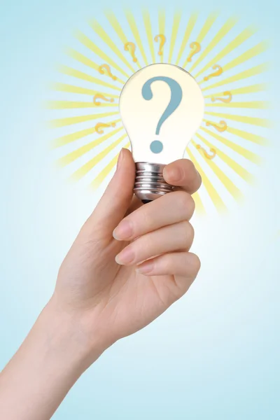 Question mark in lightbulb on light background — Stock Photo, Image