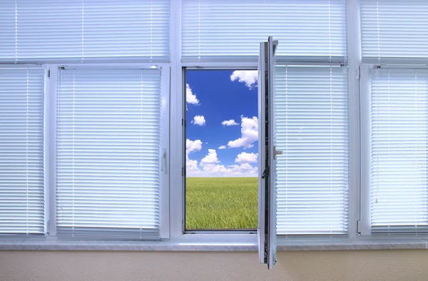 Field view through an open window in room — Stock Photo, Image