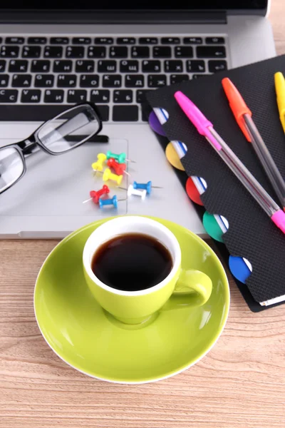 Laptop with stationery and cup of coffee on table — Stock Photo, Image