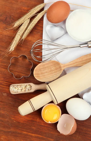 Μαγείρεμα έννοια. βασικά συστατικά ψησίματος και εργαλεία κουζίνας στο ξύλινο τραπέζι — Φωτογραφία Αρχείου