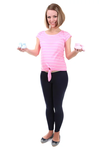 Young pregnant woman holding blue and pink baby shoes isolated on white — Stock Photo, Image