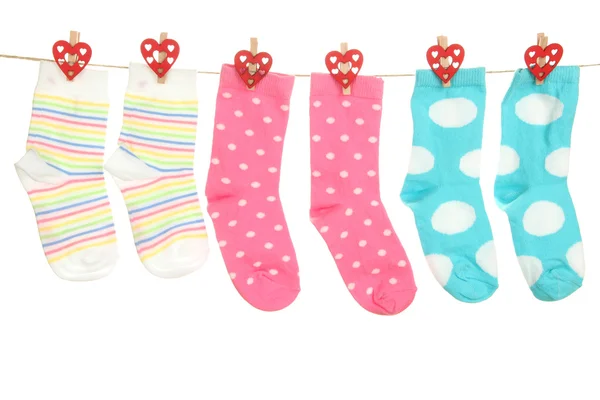 Socks hanging on clothesline isolated on white — Stock Photo, Image