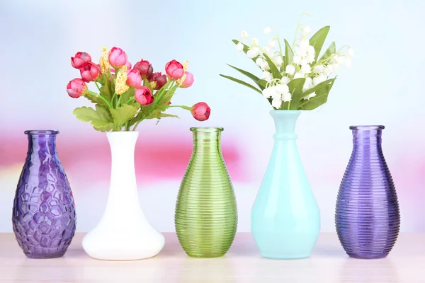 Different decorative vases on shelf on light background — Stock Photo, Image