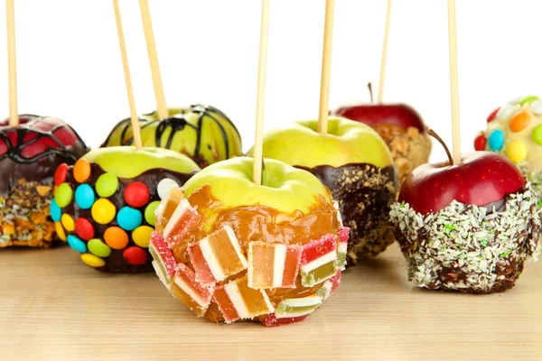 Candied apples on sticks on wooden table close up — Stock Photo, Image