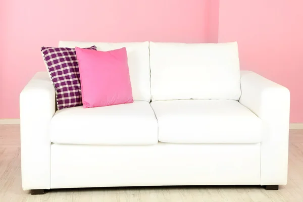 White sofa in room on pink background — Stock Photo, Image