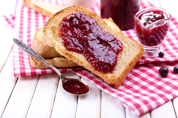 Delicious toast with jam on table close-up — Stock Photo, Image