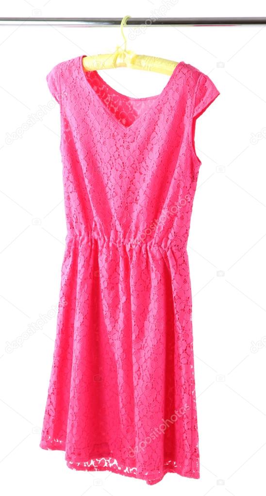 Beautiful pink dress hanging on hangers isolated on white