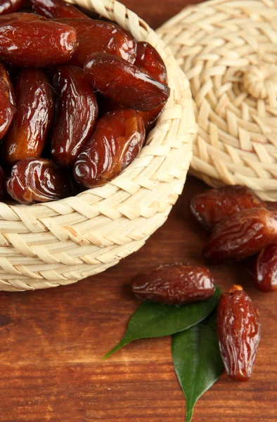 Dried dates in basket on wooden background — Stock Photo, Image