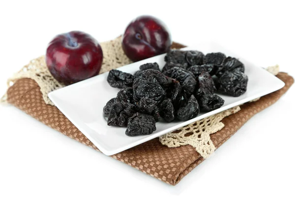 Fresh and dried plums on napkin, isolated on white — Stock Photo, Image