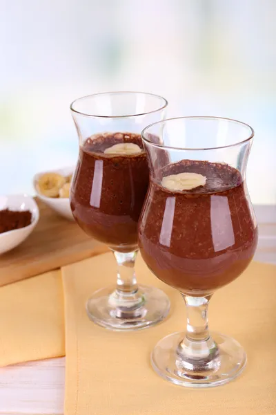 Cocktails with banana and chocolate on table on light background — Stock Photo, Image