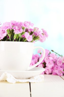 birçok küçük pembe karanfil Kupası penceresi arka plan üzerinde ahşap tablo