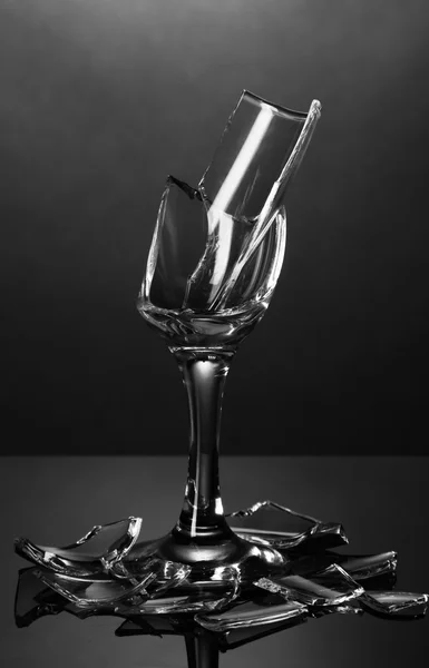 Broken wineglass on grey background — Stock Photo, Image