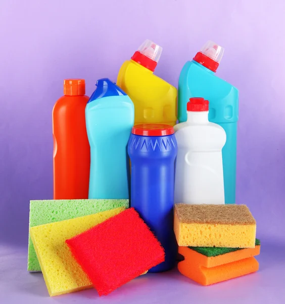 Different kinds of bath and toilet cleaners and colorful sponges, on color background — Stock Photo, Image