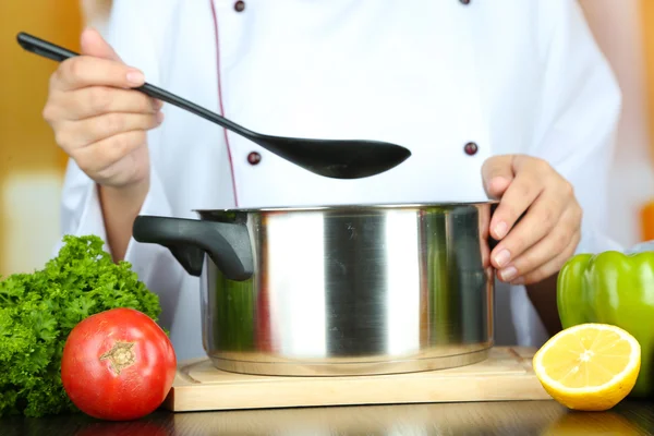 Cook hands and pan at workplace — Stock Photo, Image