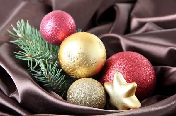 Beautiful Christmas decor on brown satin cloth — Stock Photo, Image