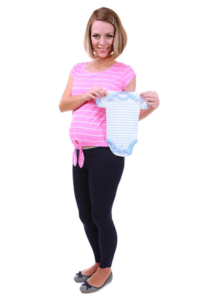 Молодая беременная женщина держит синий комбинезон изолирован на белом — стоковое фото