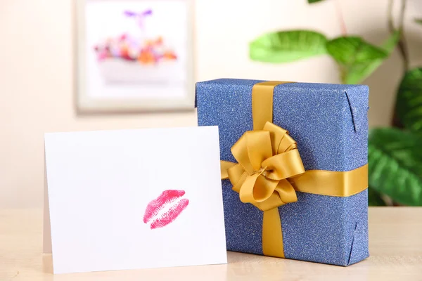 Gift with card for loved one on table on room background — Stock Photo, Image