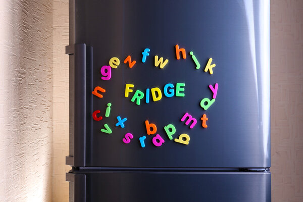 Word Fridge spelled out using colorful magnetic letters on refrigerator
