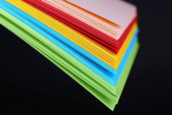 Colorful art paper on black background — Stock Photo, Image