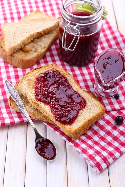 Delicious toast with jam on table close-up — Stock Photo, Image