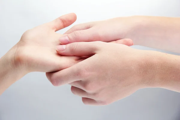 Hand massage, op grijze achtergrond — Stockfoto